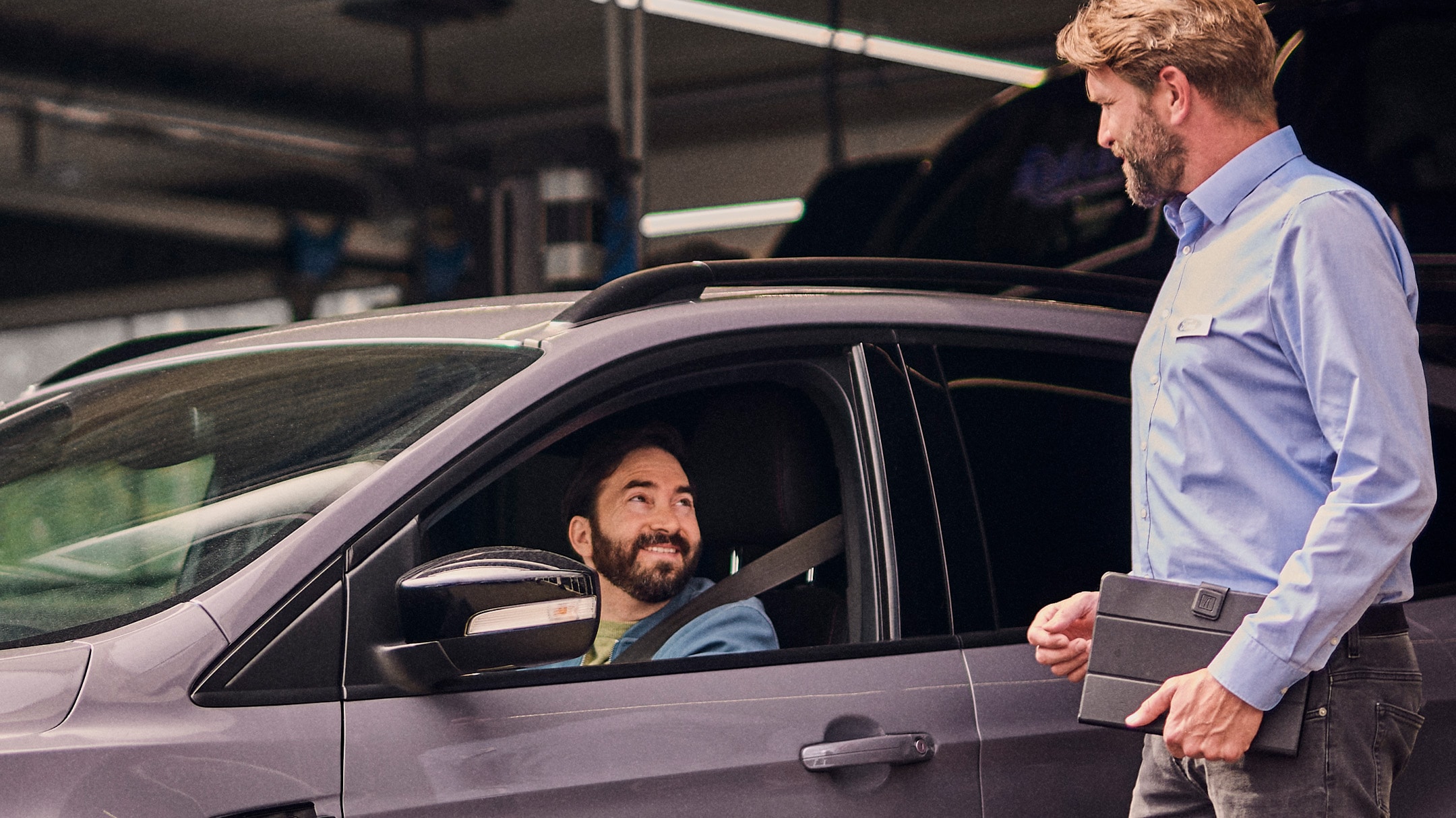 Smiling Ford Service customer in Grey Ford