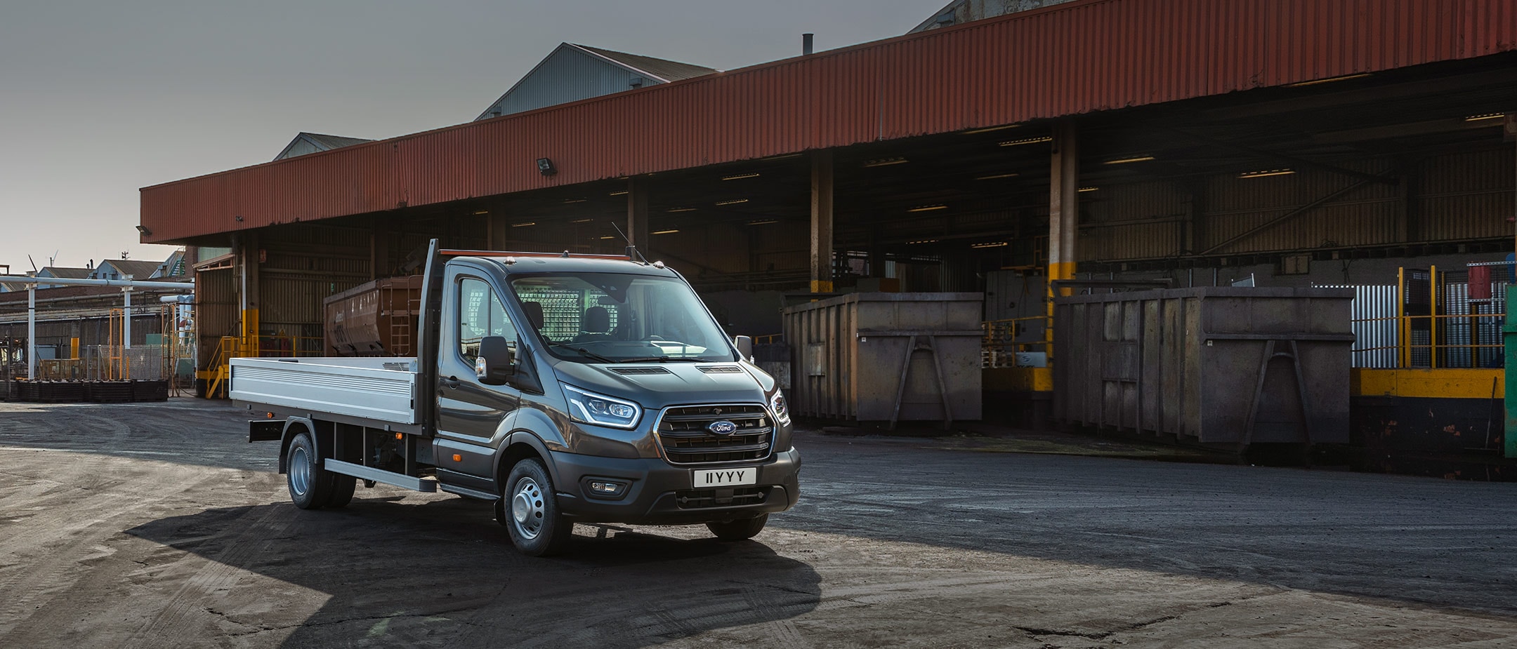 Transit Chassis Cab standing in front of warehouse in 3/4 view